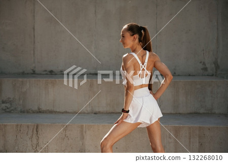 Rear view. Young skinny fitness woman is outdoors Rear view. Young skinny fitness woman is outdoors 132268010