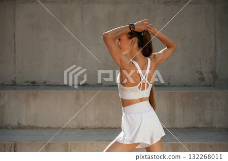 Rear view. Young skinny fitness woman is outdoors Rear view. Young skinny fitness woman is outdoors 132268011