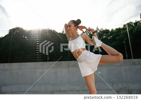 Weekend activity. Young skinny fitness woman is outdoors 132268019