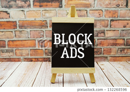 Block Ads text with blackboard on wooden background 132268596