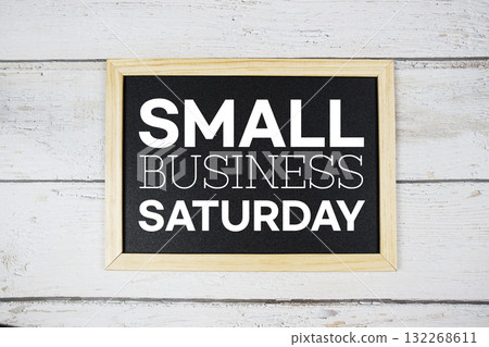 Small Business Saturday text with blackboard on wooden background Small Business Saturday text with blackboard on wooden background 132268611