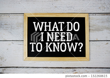 What Do I Need to Know? text with blackboard on wooden background 132268615