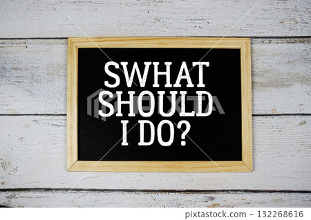 What Should I Do? text with blackboard on wooden background What Should I Do? text with blackboard on wooden background 132268616