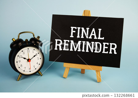 Final Reminder text with easel and alarm clock on blue background 132268661