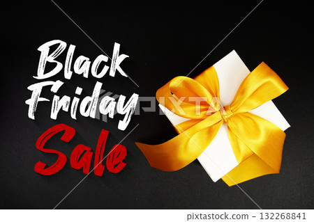 Black Friday Sale text with gift box present on black background Black Friday Sale text with gift box present on black background 132268841
