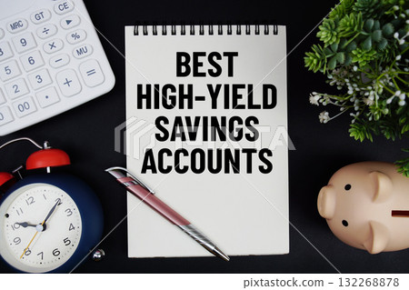 Best High-Yield Savings Accounts text with calculator with alarm clock and piggy bank on black background Best High-Yield Savings Accounts text with calculator with alarm clock and piggy bank on black background 132268878