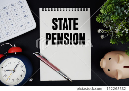 State Pension text with calculator with alarm clock and piggy bank on black background 132268882