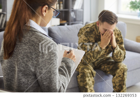Young soldier with PTSD symptoms, anxiety and stress meeting with psychologist Young soldier with PTSD symptoms, anxiety and stress meeting with psychologist 132269353
