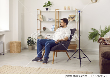 Young man sitting in armchair during intravenous therapy 132269372