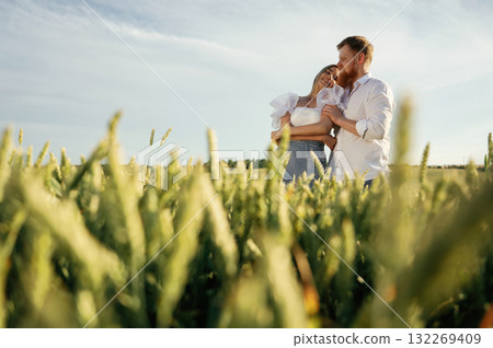 Non urban view, leisure. Lovely couple are on the green agricultural field together 132269409
