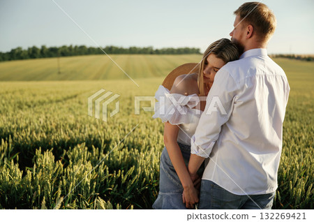 Lovely couple are on the green agricultural field together Lovely couple are on the green agricultural field together 132269421