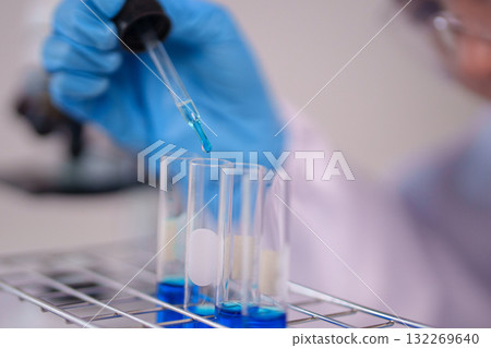 Scientist Hand Pipetting Blue Liquid Test Tubes Scientific Experiment Chemistry Lab Research Analysis Modern Laboratory Scientist Hand Pipetting Blue Liquid Test Tubes Scientific Experiment Chemistry Lab Research Analysis Modern Laboratory 132269640
