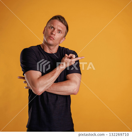 Showing to the side, pointing. Man is against background in the studio 132269710