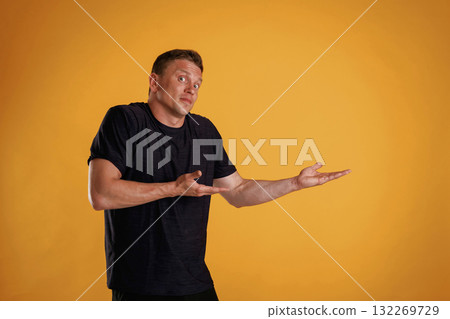 Confused, don't know what to do. Man is against background in the studio 132269729