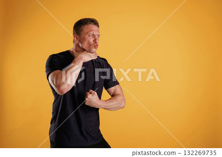 Struggle, showing muscles. Man is against background in the studio 132269735