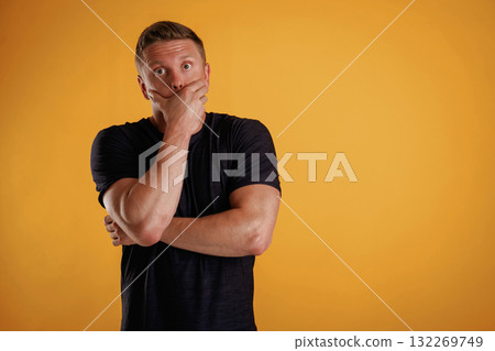Scared, feeling stressful. Man is against background in the studio Scared, feeling stressful. Man is against background in the studio 132269749