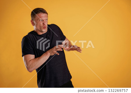 Disgusting, looking to the side, copy space. Man is against background in the studio Disgusting, looking to the side, copy space. Man is against background in the studio 132269757