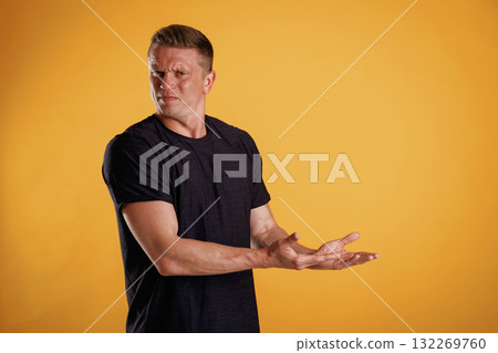 Invisible copy space, arms. Man is against background in the studio Invisible copy space, arms. Man is against background in the studio 132269760
