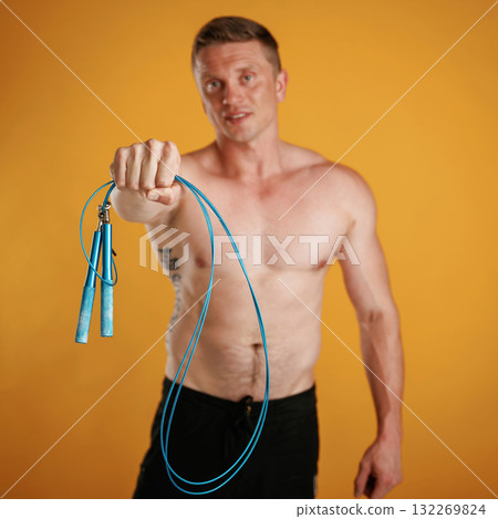 Blue jumping rope, fitness conception. Man is against background in the studio Blue jumping rope, fitness conception. Man is against background in the studio 132269824