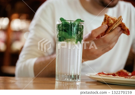 Close up view of man that is eating pizza, sitting Close up view of man that is eating pizza, sitting 132270159