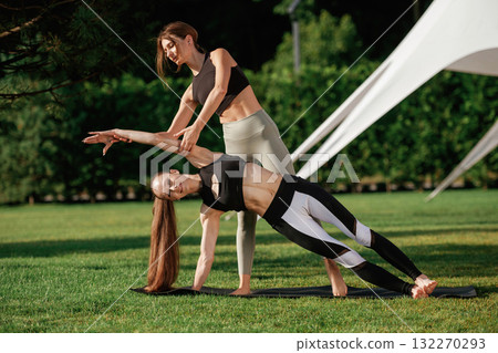 Trainer is teaching. Two fitness women are together outdoors, conception of sport 132270293