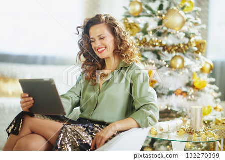 Relaxed Woman with Tablet in Holiday Setting 132270399