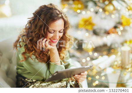 Content Woman Engaging with Tablet, Festive Mood 132270401