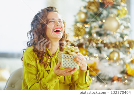 Joyful Woman Laughing with Polka-Dot Gift Joyful Woman Laughing with Polka-Dot Gift 132270404