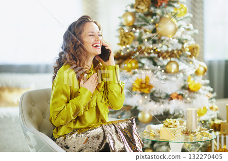 Joyful Woman Laughing on Christmas Phone Call Joyful Woman Laughing on Christmas Phone Call 132270405