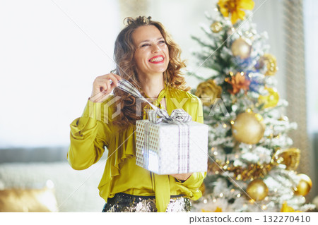 Cheerful Woman with a Wrapped Christmas Gift Cheerful Woman with a Wrapped Christmas Gift 132270410