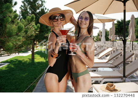Two female friends are on resort, have a vacation at a beautiful place Two female friends are on resort, have a vacation at a beautiful place 132270448