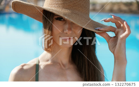 Portrait, in the straw hat. Beautiful young woman is at resort, vacation Portrait, in the straw hat. Beautiful young woman is at resort, vacation 132270675