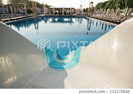 Pool slide, clean water in the vacation place, distant view Pool slide, clean water in the vacation place, distant view 132270686
