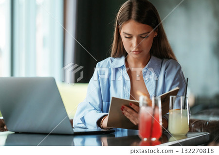 Focused at work. Beautiful woman with laptop is in the bar Focused at work. Beautiful woman with laptop is in the bar 132270818