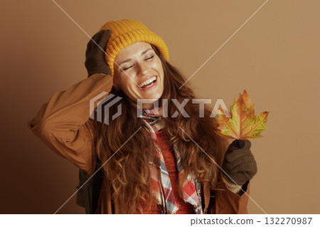 Woman Laughing Joyfully with Autumn Leaf Woman Laughing Joyfully with Autumn Leaf 132270987
