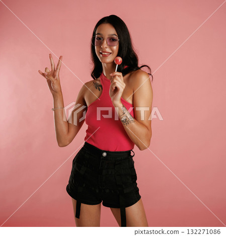Sweet lollipop. Beautiful young woman is against background Sweet lollipop. Beautiful young woman is against background 132271086