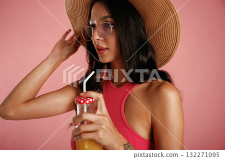 Fresh drink. Beautiful young woman is against background Fresh drink. Beautiful young woman is against background 132271095