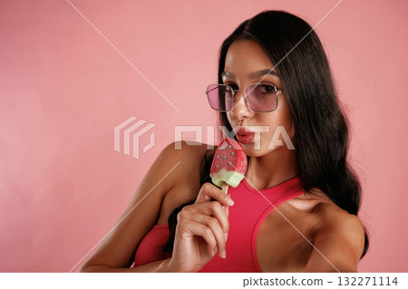 Fruit ice cream. Beautiful young woman is against background Fruit ice cream. Beautiful young woman is against background 132271114