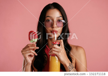 Summer fresh ice cream and orange juice. Beautiful young woman is against background 132271118
