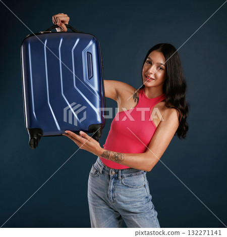 Holds a suitcase. Beautiful young woman is against background Holds a suitcase. Beautiful young woman is against background 132271141