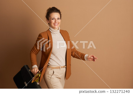 Confident Businesswoman Walking with Autumn Leaves 132271240