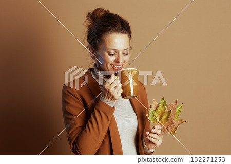 Content Businesswoman Enjoys a Cozy Autumn Moment 132271253