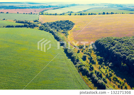 Beautiful rural landscape. View from above of sunny fields on rolling hills Beautiful rural landscape. View from above of sunny fields on rolling hills 132271308