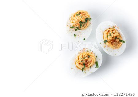 Homemade hard Boiled Deviled Eggs garnished with herbs isolated on white background 132271456
