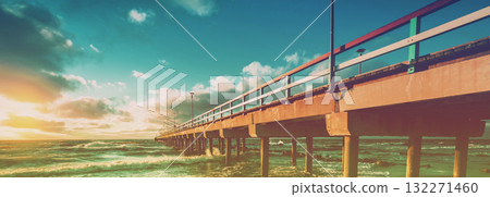 Pier and sea at sunset. View of the pier over the sea. Pier in the city of Palanga at sunset in autumn, Lithuania. Horizontal banner Pier and sea at sunset. View of the pier over the sea. Pier in the city of Palanga at sunset in autumn, Lithuania. Horizontal banner 132271460