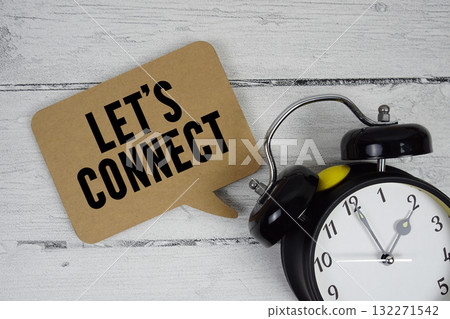 Let's connect text with alarm clock on wooden background 132271542