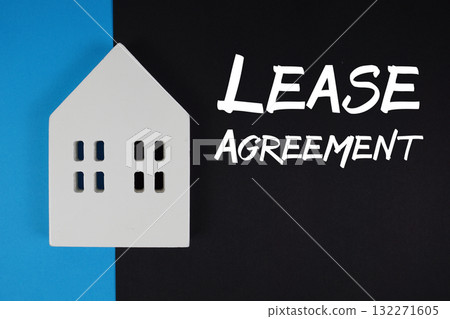 Lease Agreement text with house models on black background Lease Agreement text with house models on black background 132271605