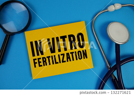 IVF In Vitro Fertilization text with Stethoscope and magnifying glass on blue background 132271621