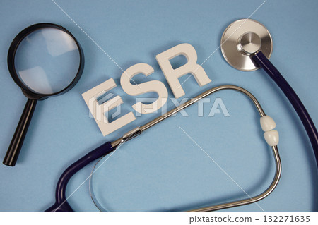 ESR Erythrocyte Sedimentation Rate alphabet letters with Stethoscope and magnifying glass on blue background 132271635