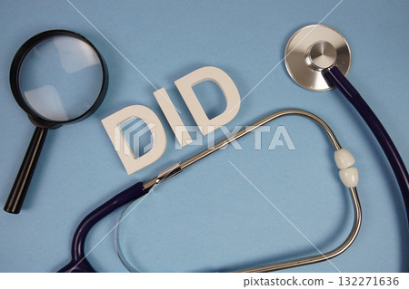 DID Dissociative Identity Disorder alphabet letters with Stethoscope and magnifying glass on blue background 132271636